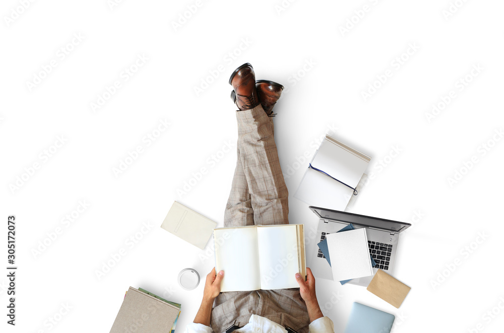 Young man sitting and reading a book on the floor, education concept