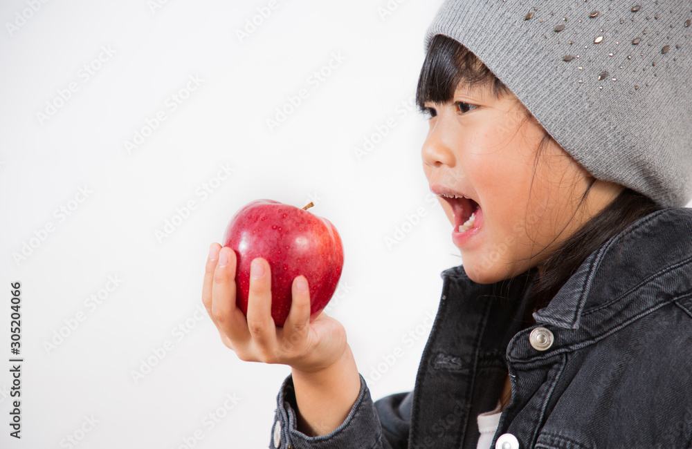 The image of an Asian girl holding a red  apple in his hand is healthy and good for a white backgrou