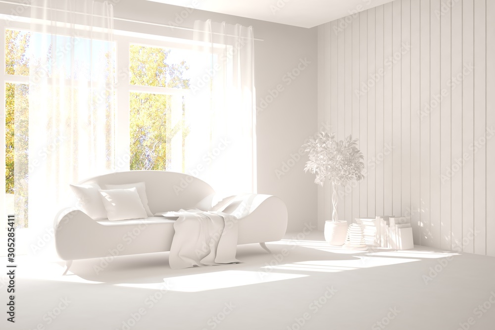 Stylish room in white color with sofa and autumn landscape in window. Scandinavian interior design. 