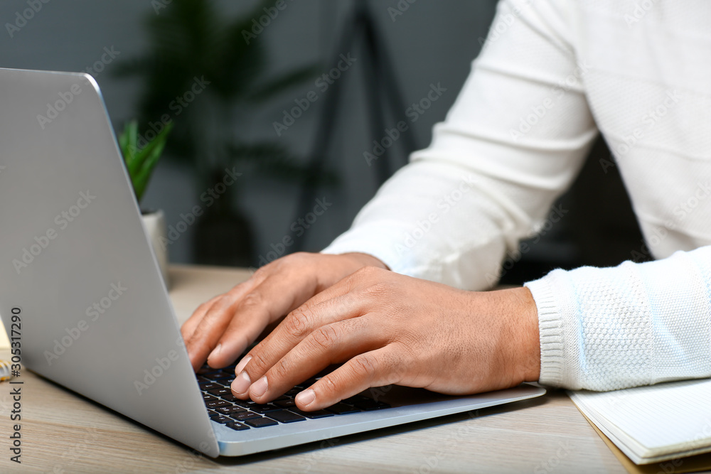 Asian programmer working late in evening