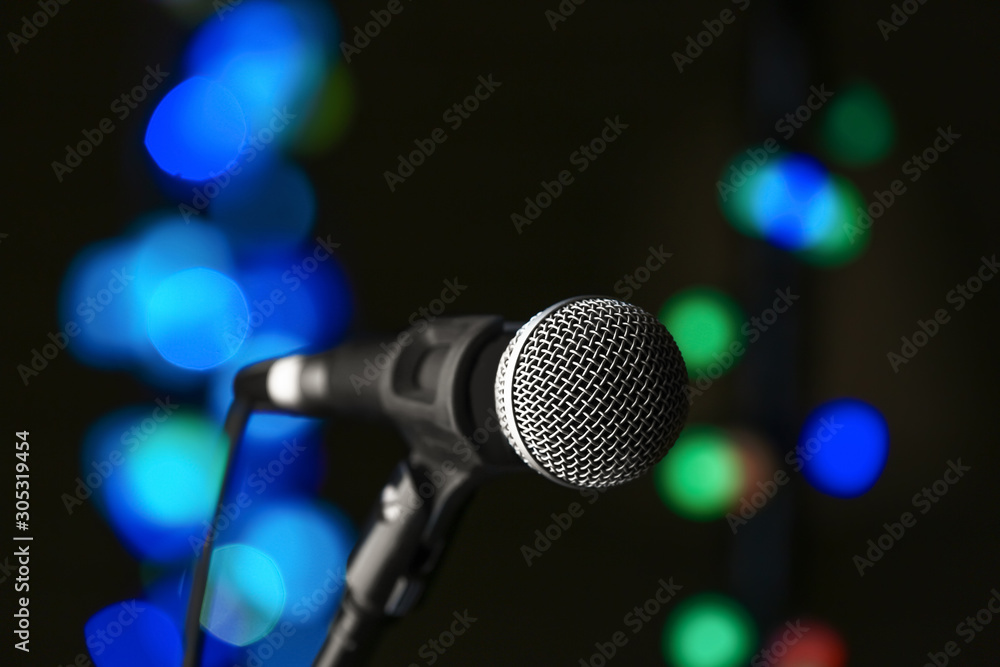 Microphone on dark background with defocused lights