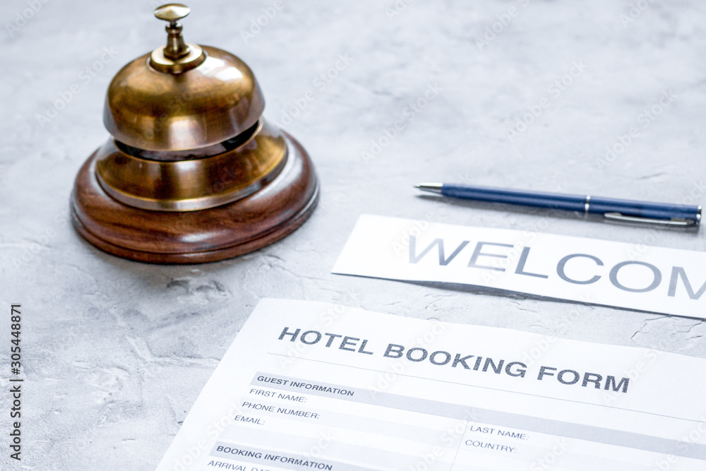 hotel reservation blank and ring on stone background