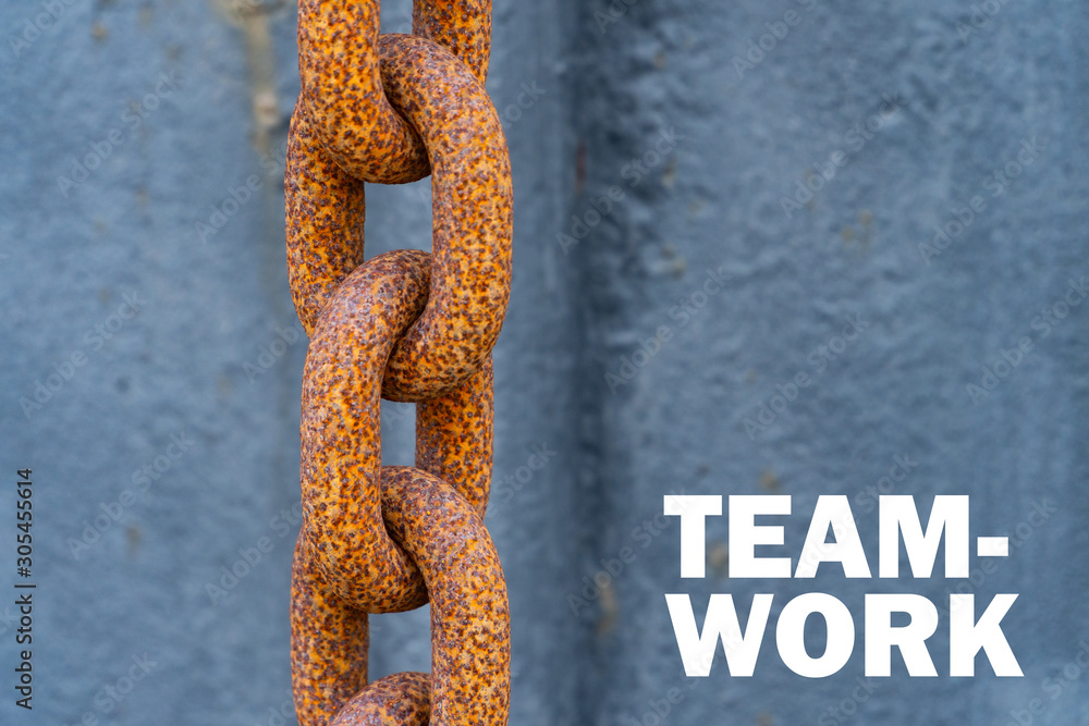 A big rusty chain with the words Team Work