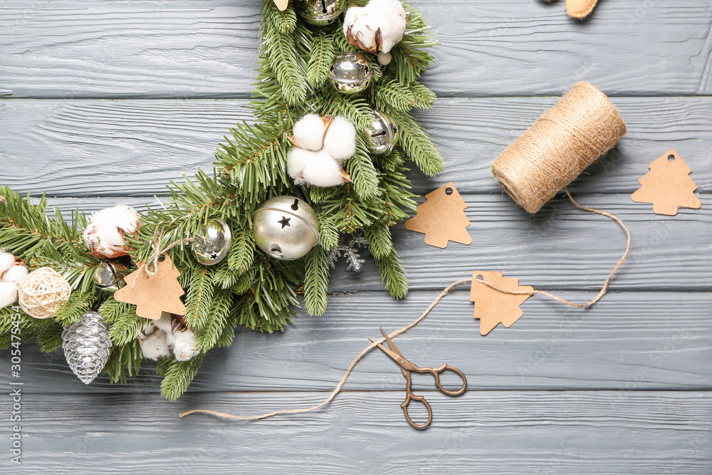 Beautiful Christmas wreath and decor on wooden background