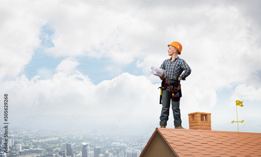 Engineer in hardhat with technical blueprints