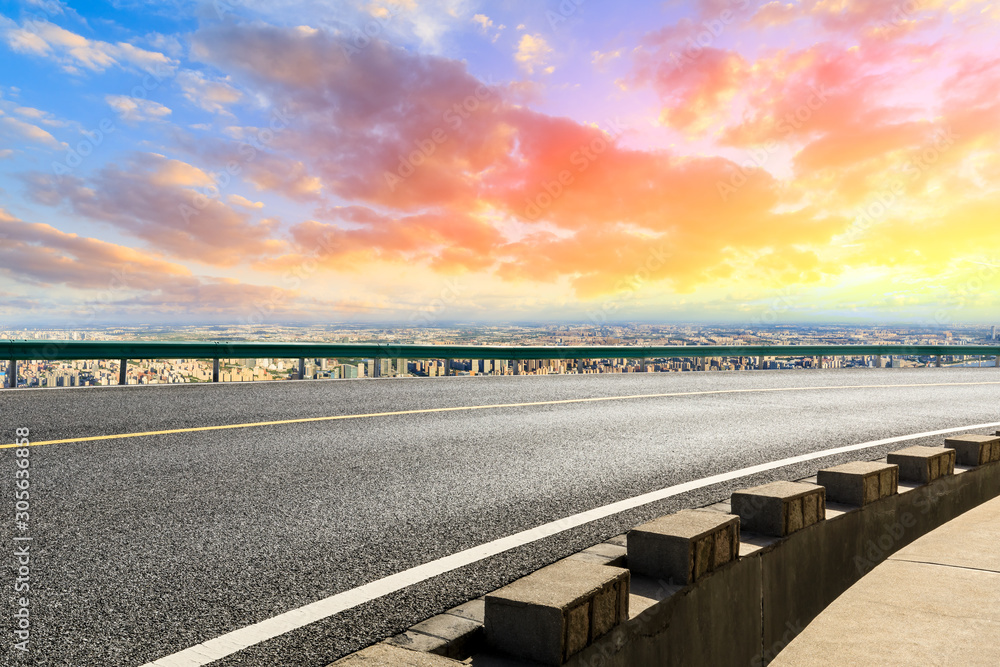 Shanghai city skyline and empty asphalt road scenery at sunset.