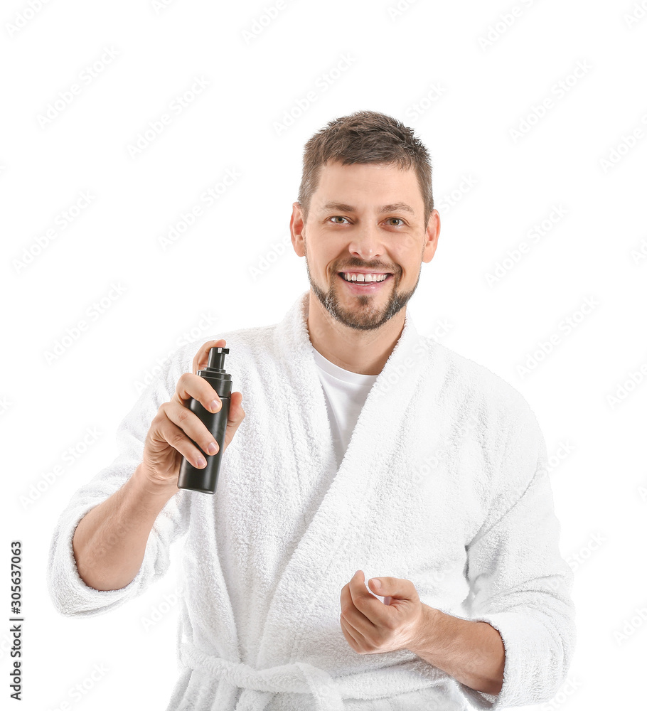 Handsome man with cosmetic product on white background