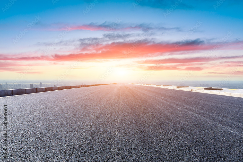 Shanghai city skyline and empty asphalt road scenery at sunset.