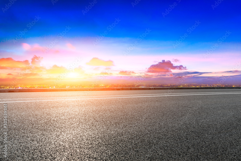 Shanghai city skyline and empty asphalt road scenery at sunset.