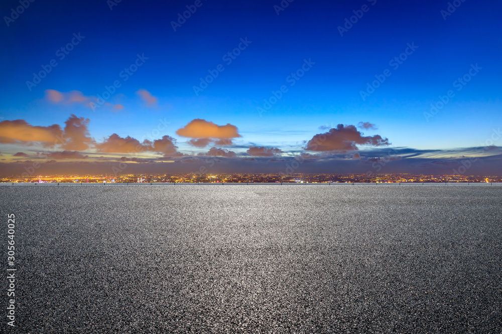 Shanghai city skyline and empty asphalt road scenery at sunset.