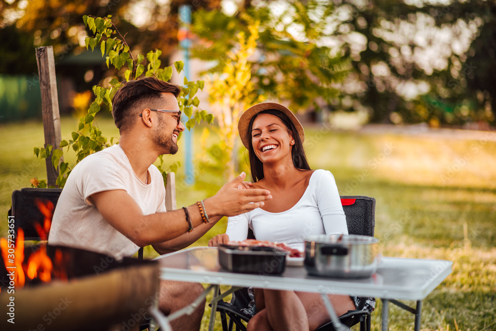 Young couple relaxing in backyard.