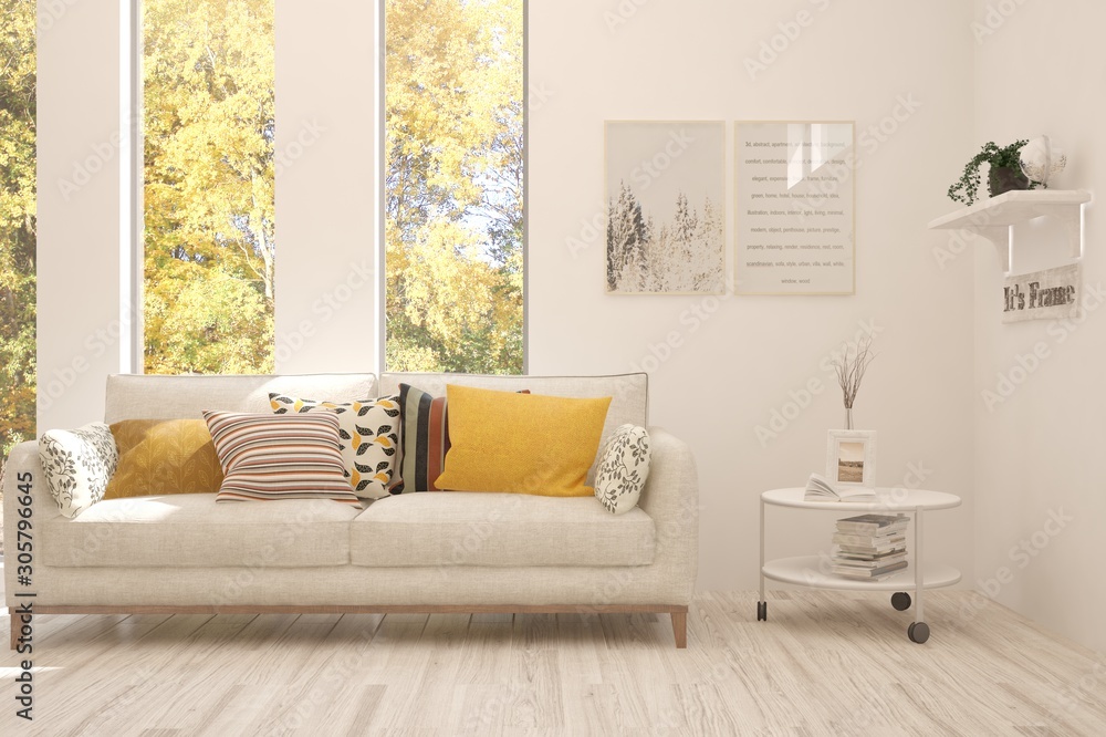 Stylish room in white color with sofa and autumn landscape in window. Scandinavian interior design. 