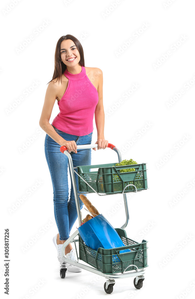 Young woman with shopping cart on white background