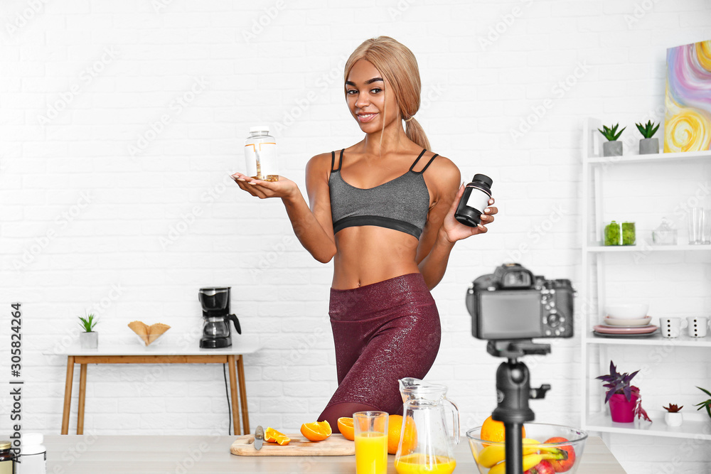 African-American blogger recording video about sport and healthy food at home