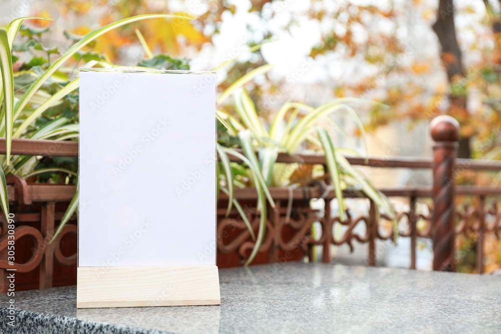 Empty menu on table in outdoor cafe