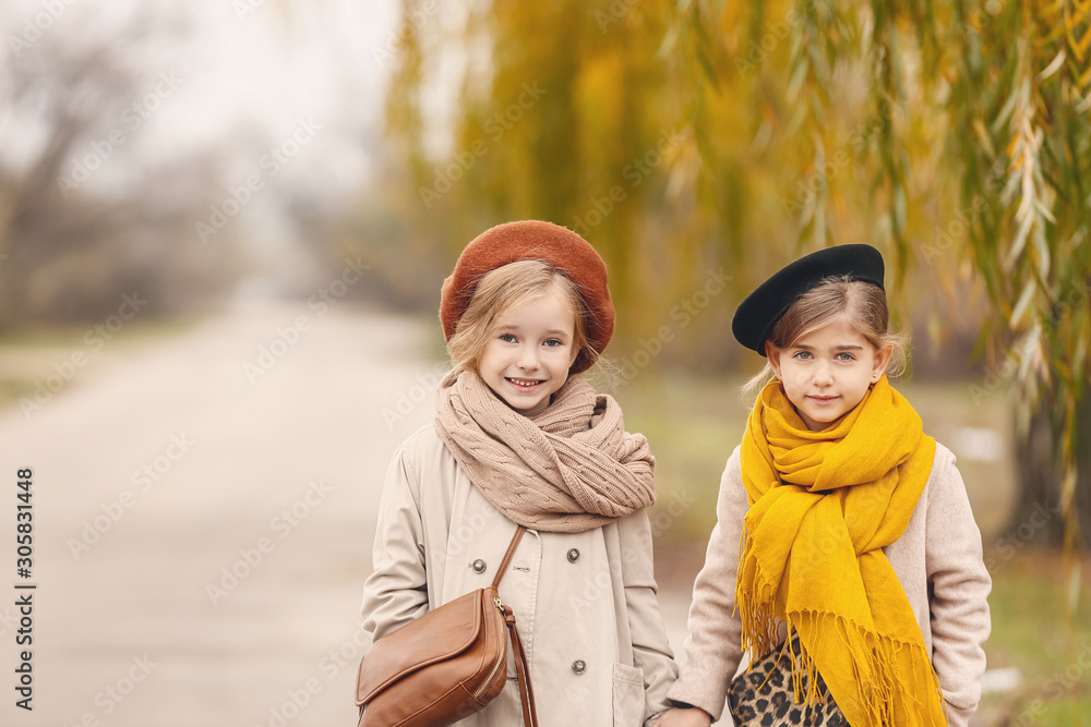 Cute little girls in autumn clothes outdoors