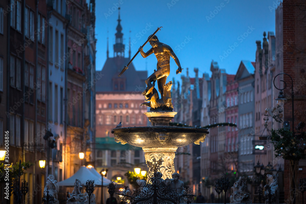 Beautiful architecture of the old town in Gdansk with Neptune fountain at dawn, Poland