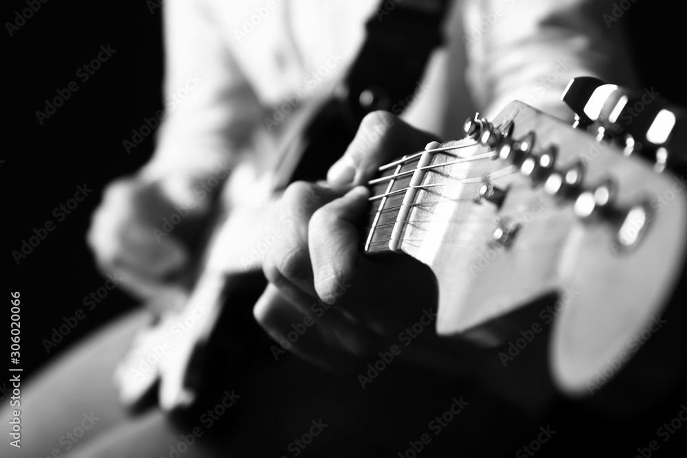 Black and white photo of man with guitar, closeup