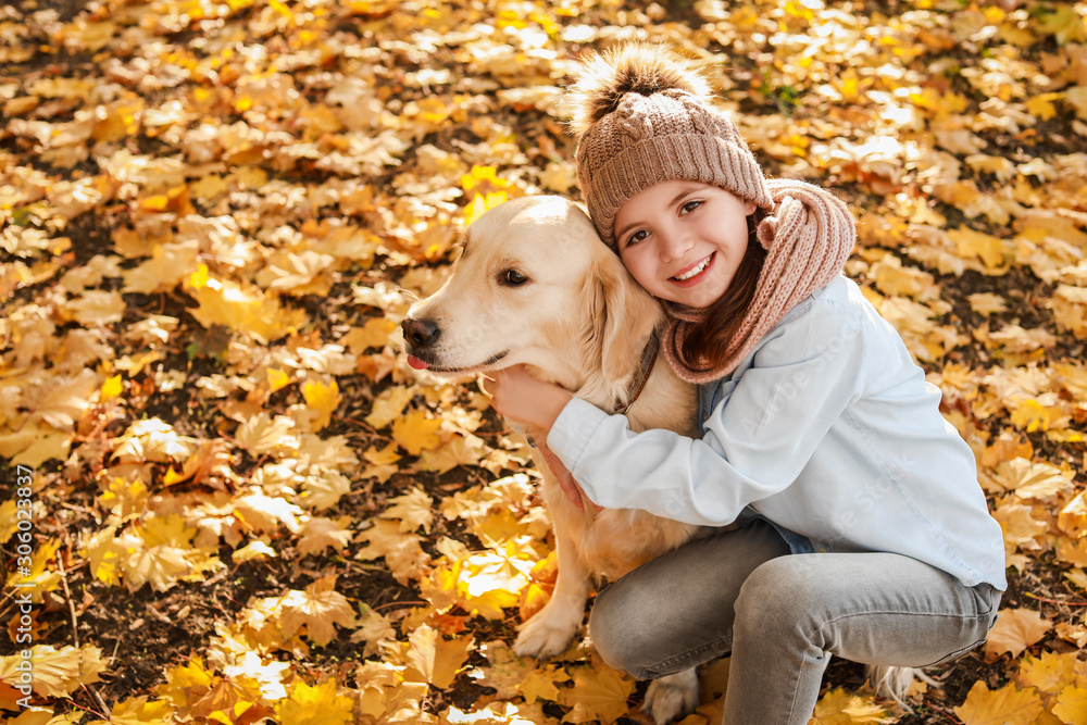 Little girl with cute dog in autumn park