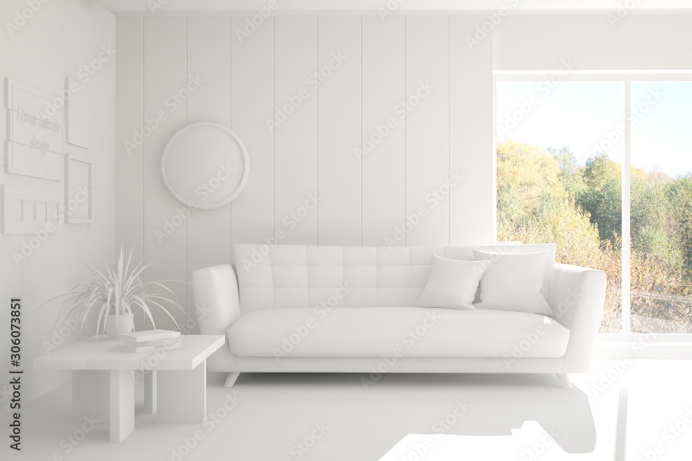 Stylish room in white color with sofa and autumn landscape in window. Scandinavian interior design. 