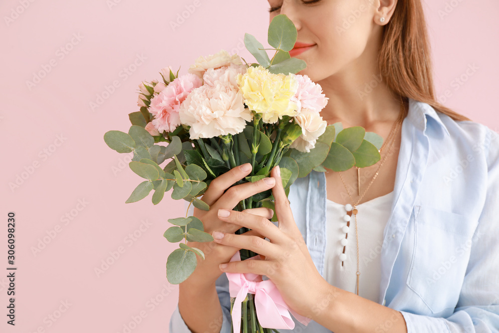 Beautiful young woman with bouquet of carnation flowers on color background