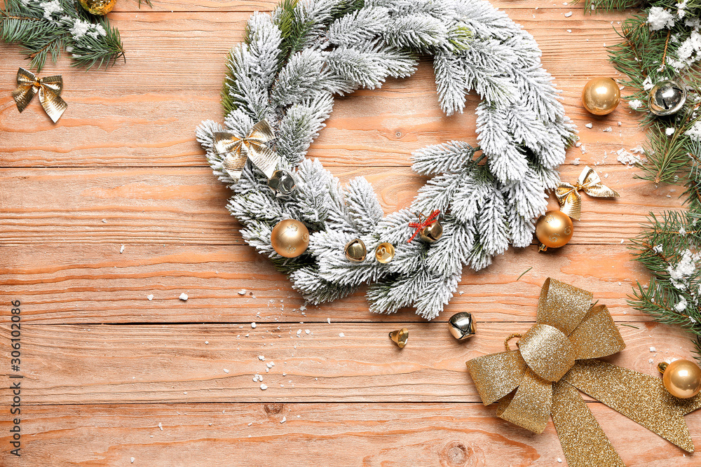 Beautiful Christmas wreath and decor on wooden background