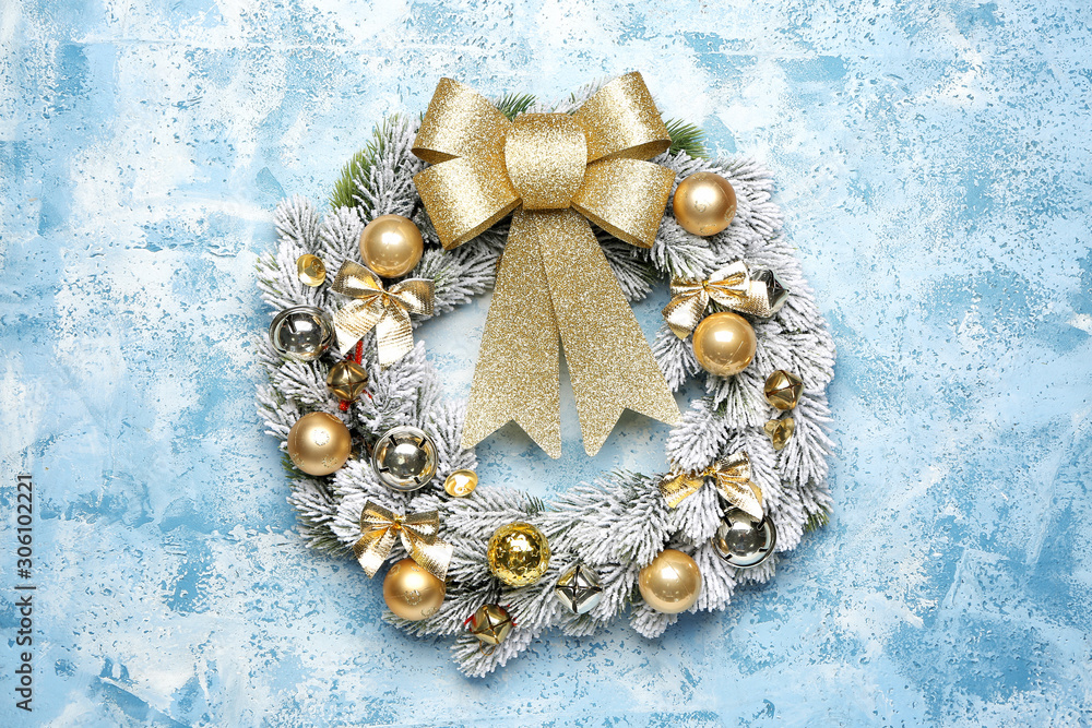 Beautiful Christmas wreath on color background