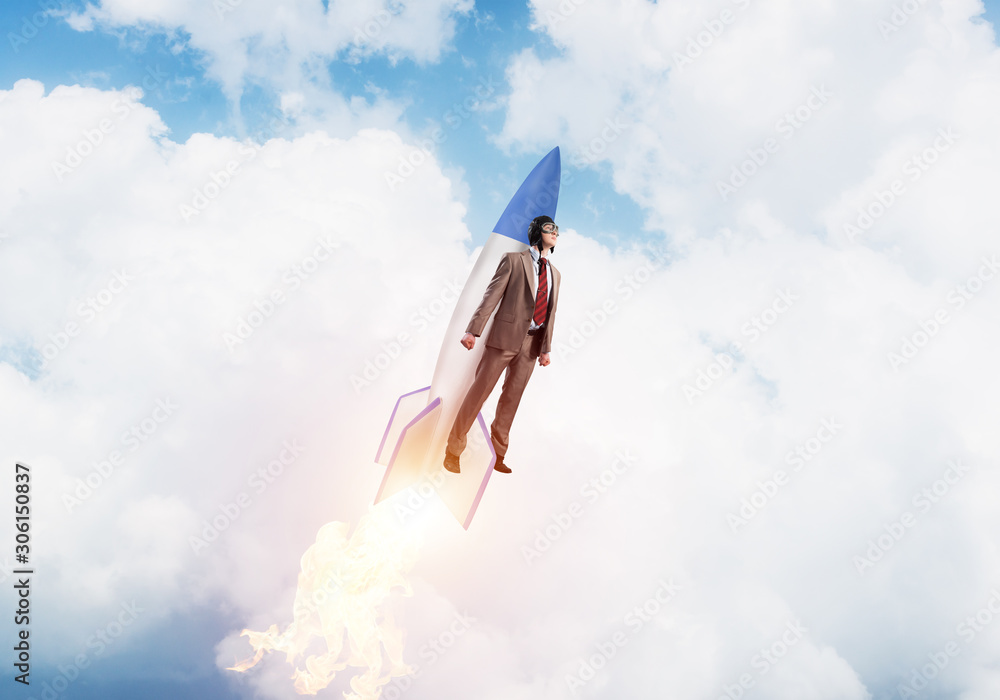 Business person in aviator hat flying on rocket