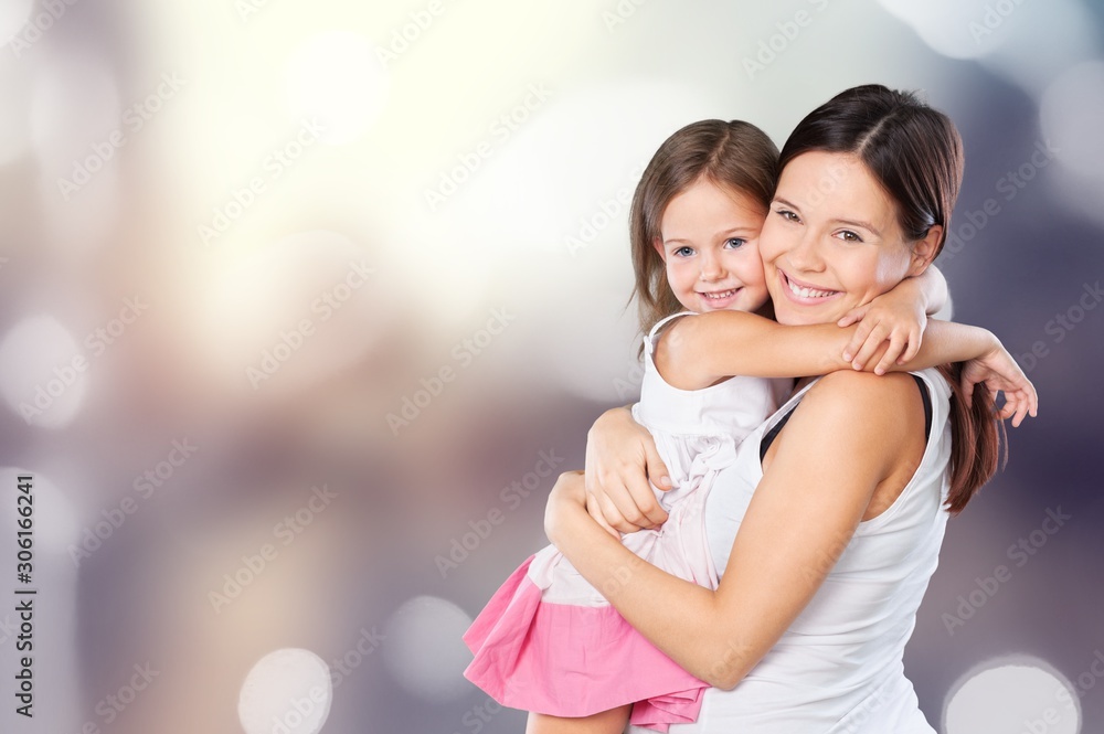 Happy Mother and daughter hugging on bokeh background