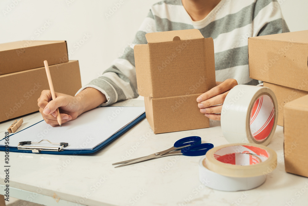 Courier holding carton box and delivery receipt