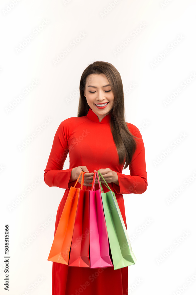 Asian women wearing traditional ao dai clothes holding shopping bags