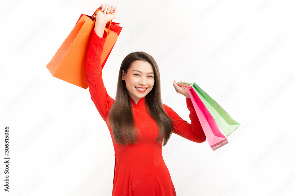 Lunar new year woman concept, Asian woman wear red dress holding shopping bags on white background