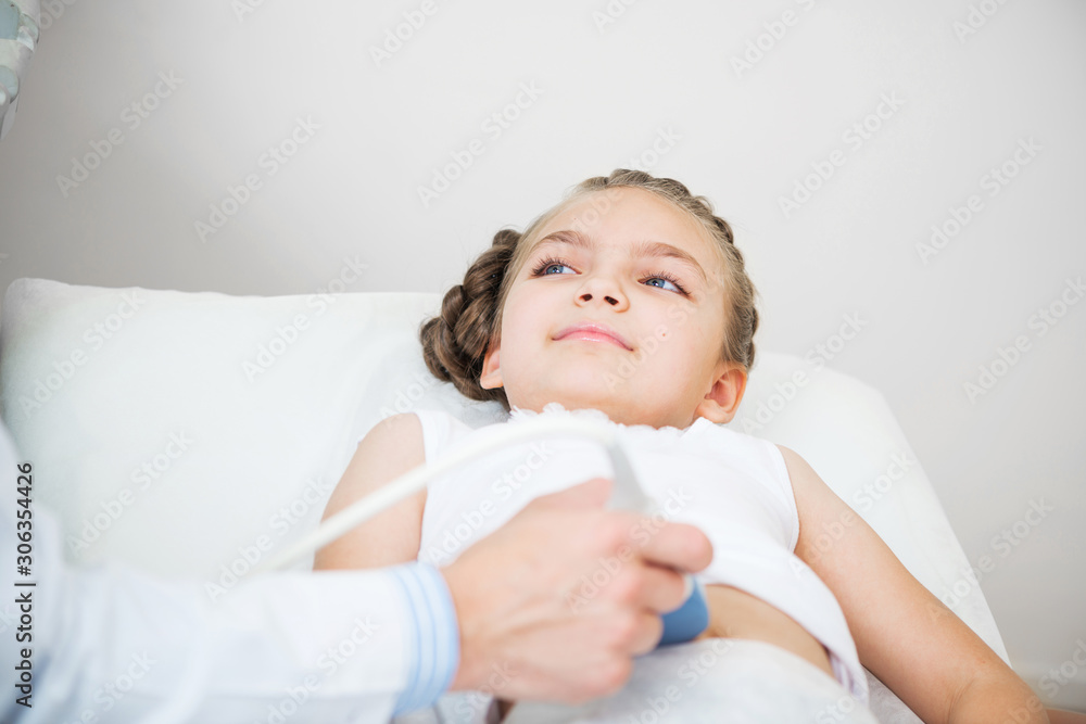 Medical examination of smiling little girl