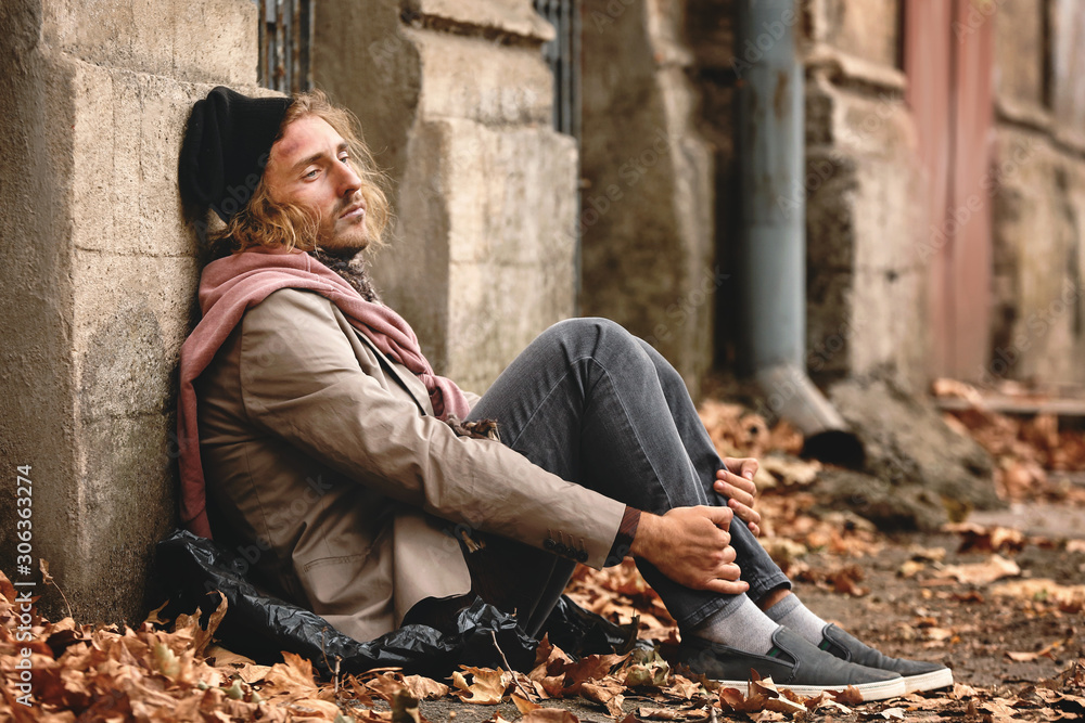 Portrait of poor homeless man outdoors