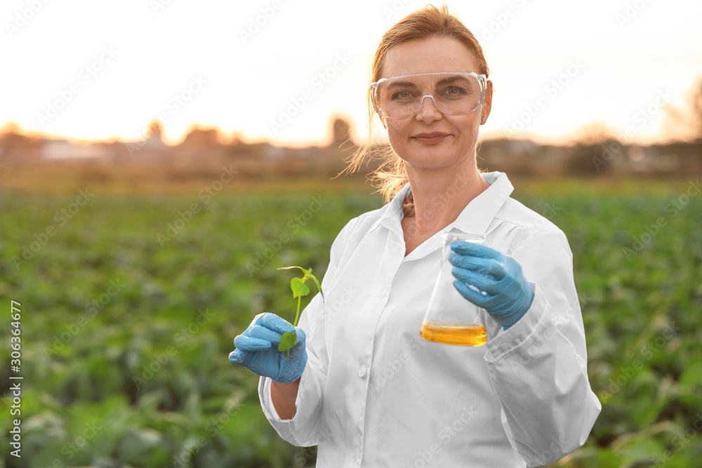 Female agricultural engineer working in field