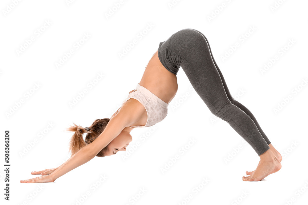 Beautiful young woman practicing yoga on white background