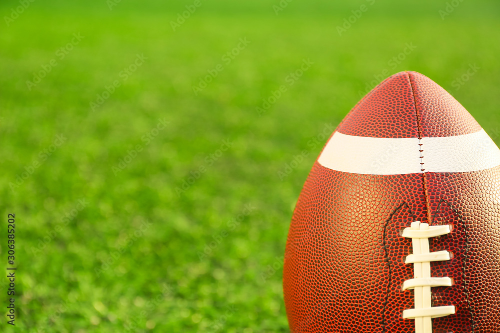 Rugby ball on green field outdoors