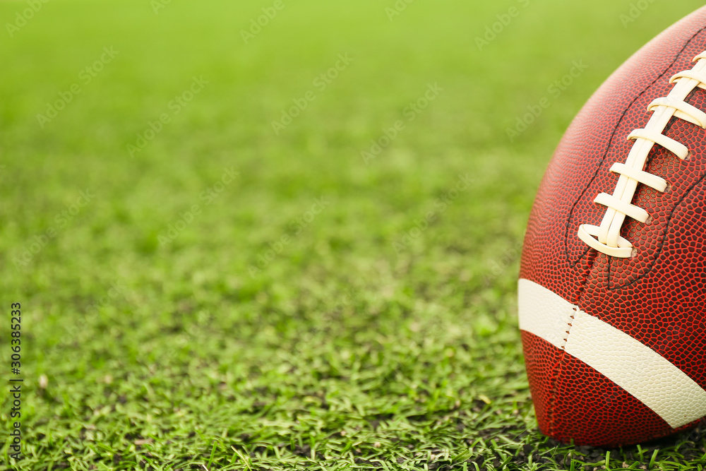 Rugby ball on green field outdoors