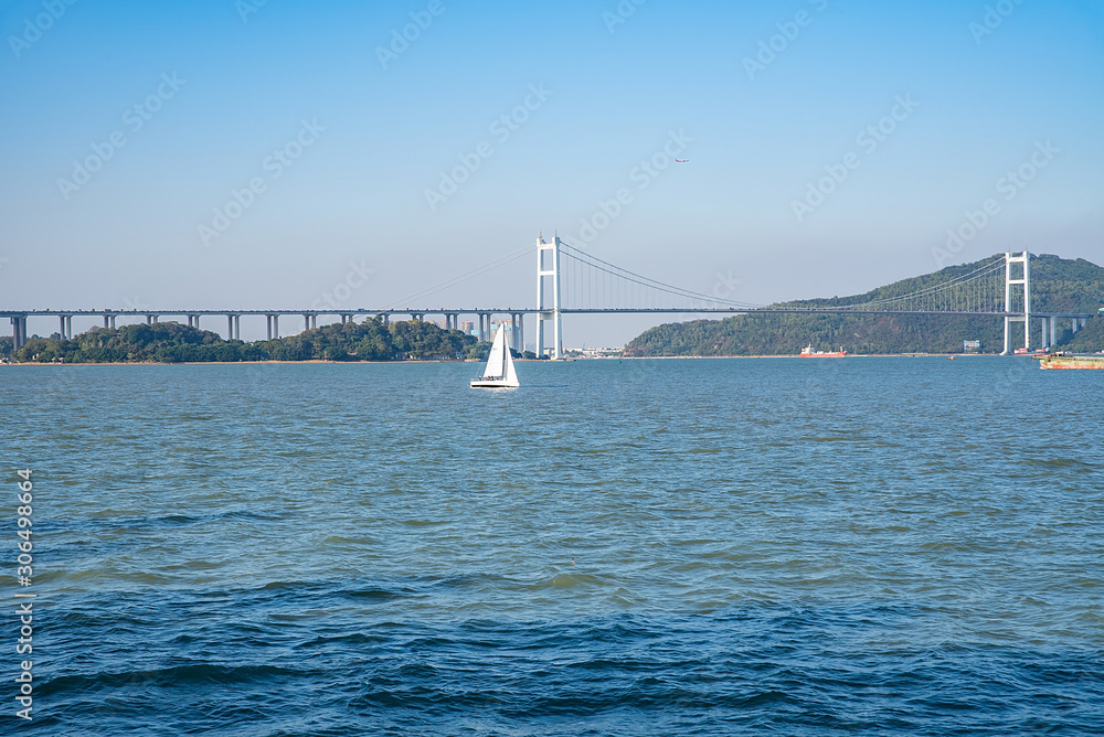 Prospect of sailing boat and Humen Bridge above the Pearl River Estuary, Guangdong, China