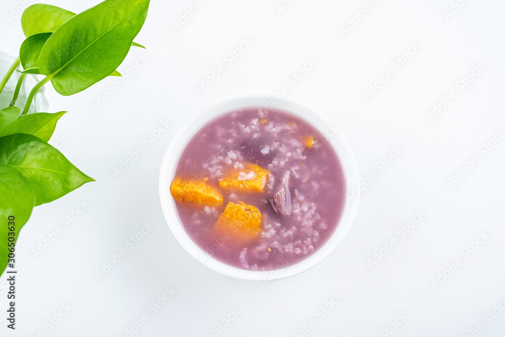 Purple sweet potato porridge in a bowl on white background