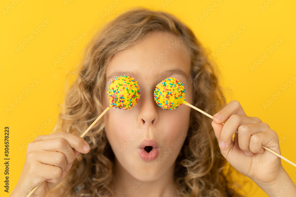 Happy child holding lollipop