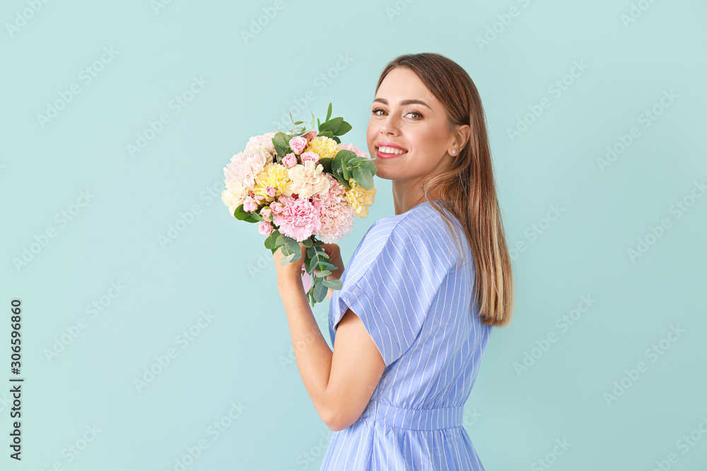 Beautiful young woman with bouquet of carnation flowers on color background