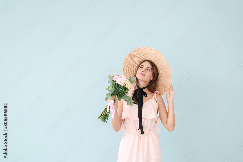 Beautiful young woman with bouquet of carnation flowers on color background