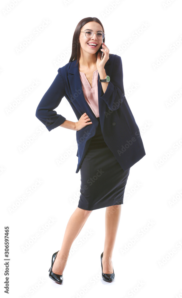 Beautiful young businesswoman talking by phone on white background