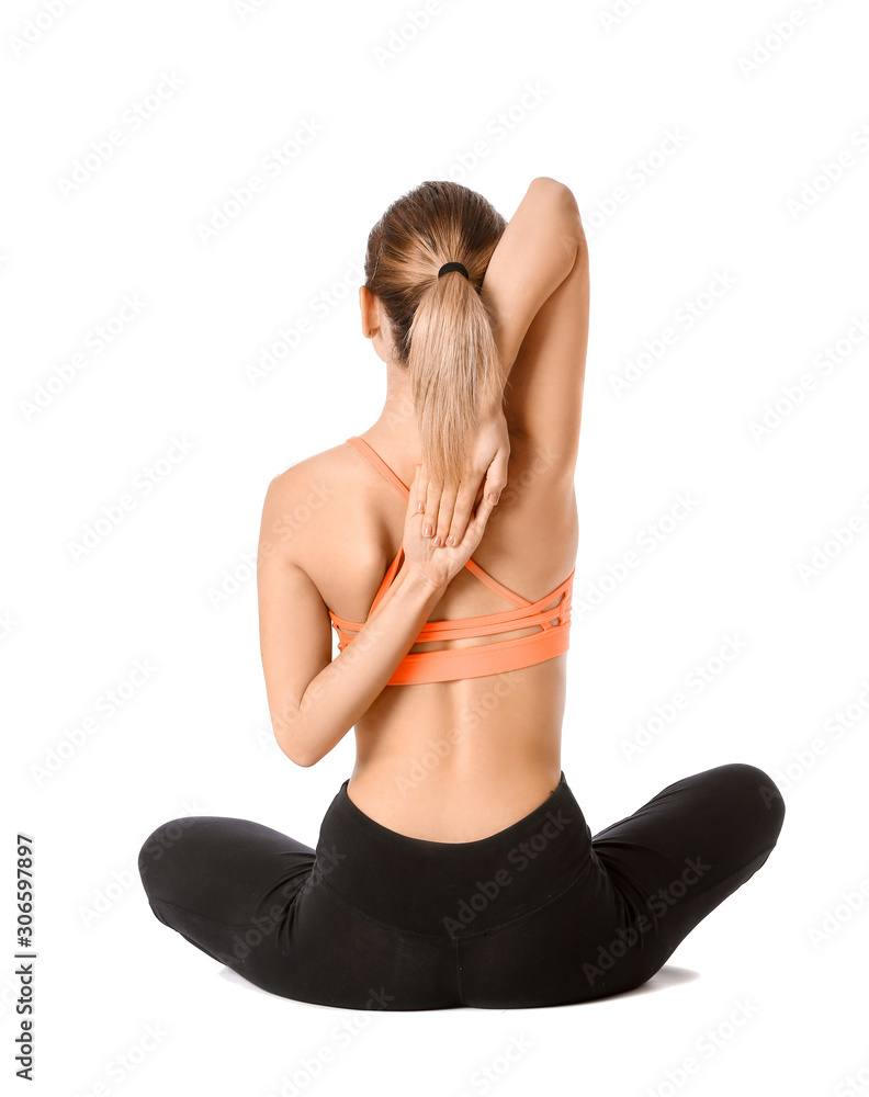 Beautiful young woman practicing yoga on white background