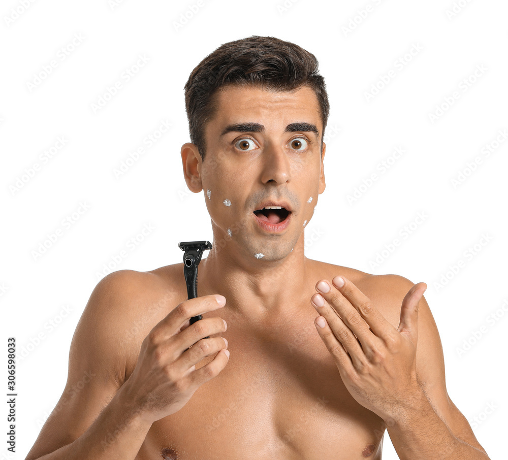 Shocked young man with razor on white background