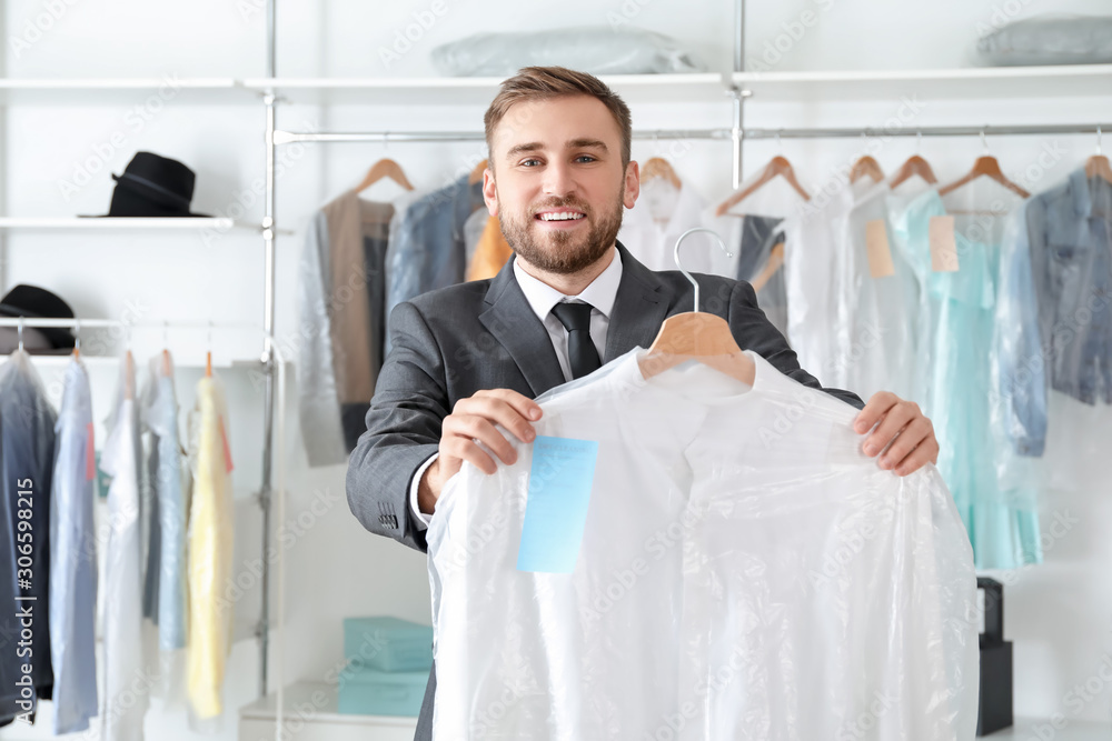 Young male worker in modern dry-cleaners