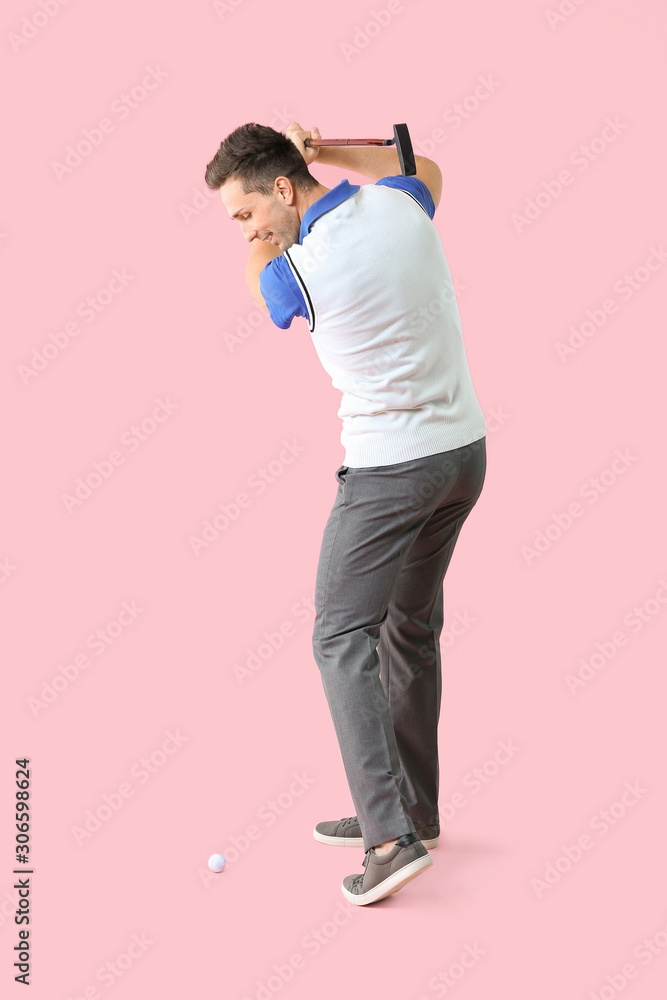 Handsome male golfer on color background