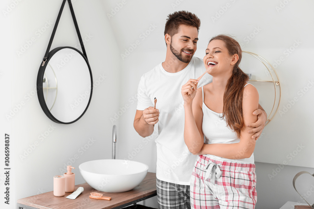 Morning of young couple brushing teeth in bathroom