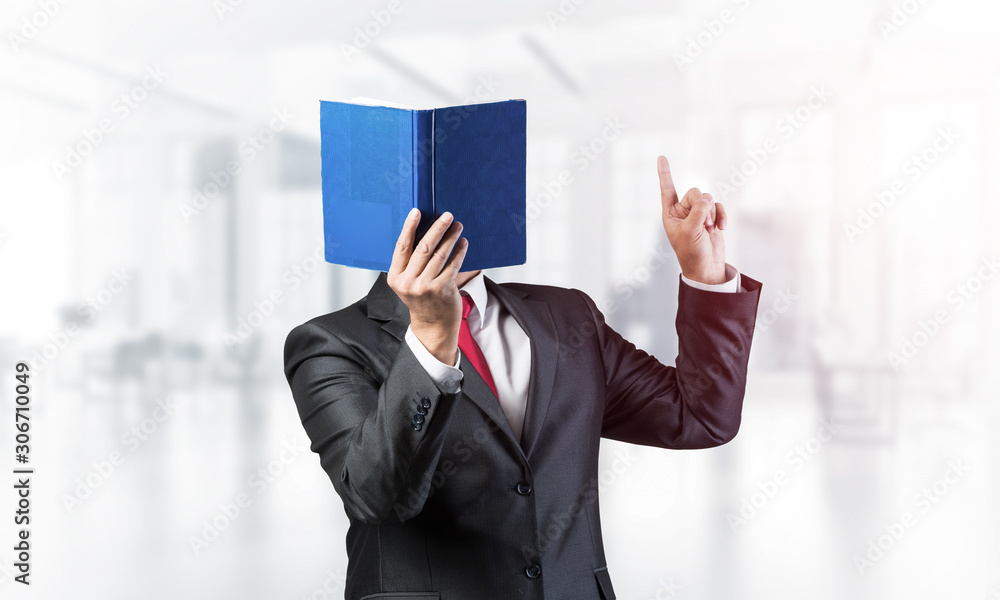 Businessman covered his face with book